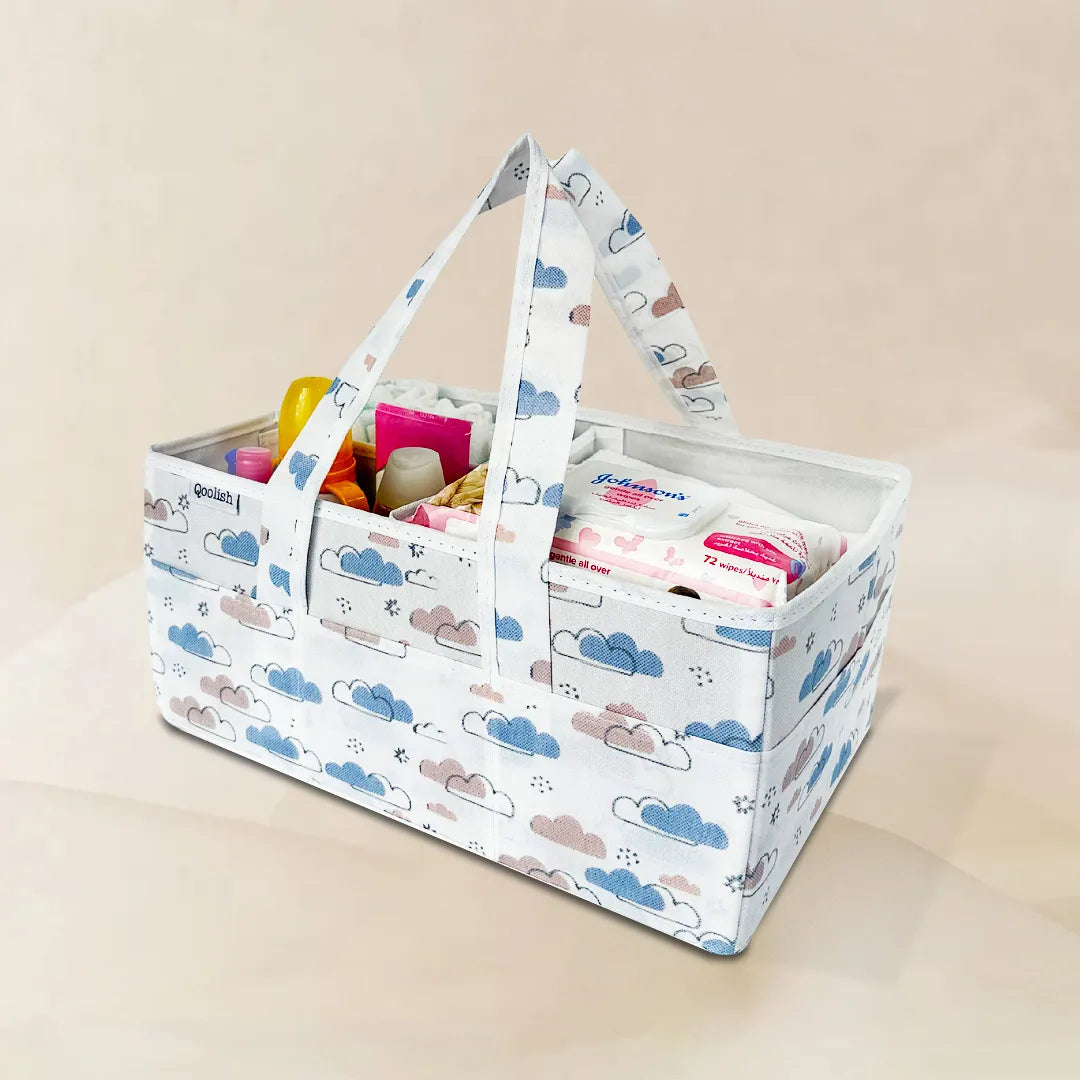 Front view of Qoolish diaper caddy featuring dreamy clouds design in warm neutral tones.